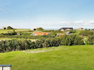 a field of green grass with houses in the background at 4 person holiday home in Lemvig-By Traum in Lemvig