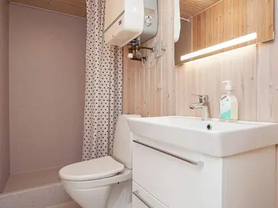 a white bathroom with a toilet and a sink at 7 person holiday home in Struer-By Traum in Remmer Strand