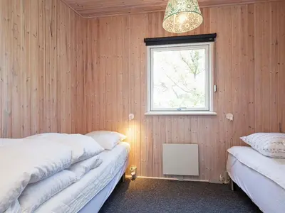 a bedroom with two beds and a window at 7 person holiday home in Struer-By Traum in Remmer Strand