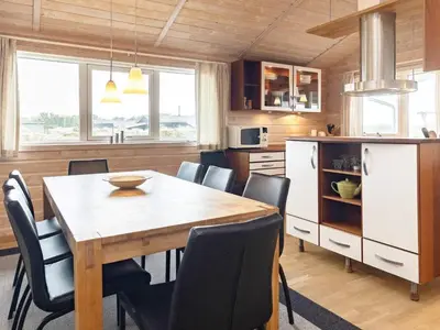 a kitchen and dining room with a table and chairs at 10 person holiday home in Thisted-By Traum in Klitmøller