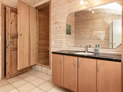 a bathroom with a sink and a mirror at 10 person holiday home in Thisted-By Traum in Klitmøller