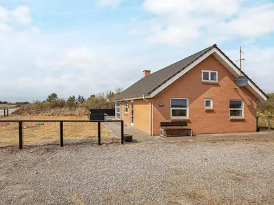 a small house with a bench in front of it at 8 person holiday home in Vestervig-By Traum in Vestervig