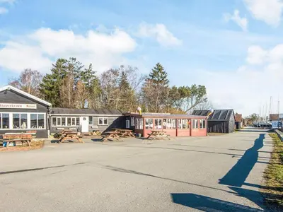 a street with a building with a picnic table at 6 person holiday home in Højslev-By Traum in Bøstrup