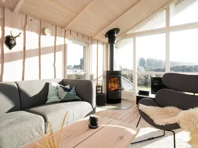 a living room with a couch and a fireplace at Tranquil Retreat in Klitmoller - By Traum Ferienwohnungen in Klitmøller