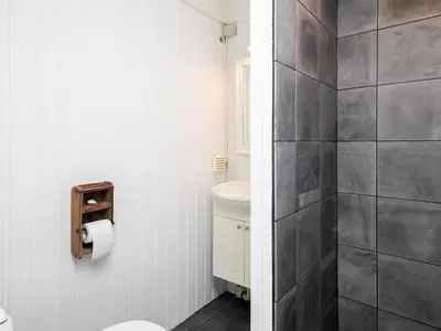 a bathroom with a toilet and a sink at Luxury Retreat with Pool - By Traum Ferienwohnungen in Torup Strand