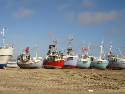 a group of boats sitting on the beach at Luxury Retreat with Pool - By Traum Ferienwohnungen in Torup Strand