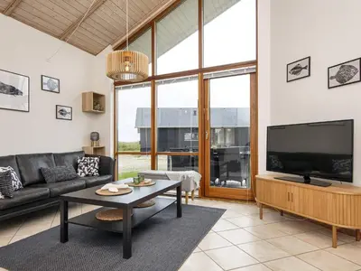 a living room with a couch and a tv at 7 person holiday home in Ulfborg-By Traum in Thorsminde