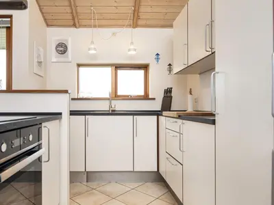a kitchen with white cabinets and a sink at 7 person holiday home in Ulfborg-By Traum in Thorsminde