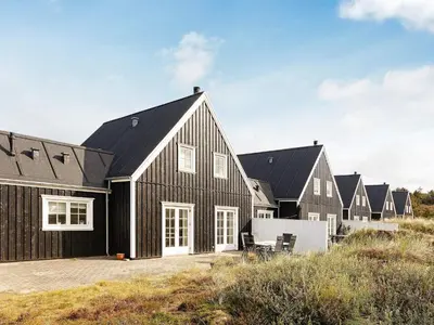 a black house with a black roof at 6 person holiday home in Blokhus-By Traum in Blokhus