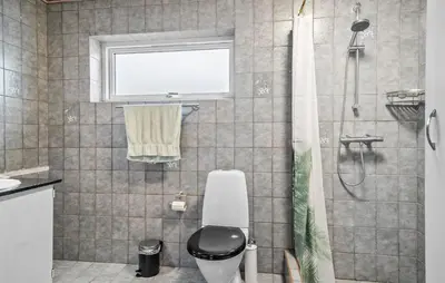 a bathroom with a shower with a toilet and a window at Lovely Home In Vemb With House Sea View in Vemb