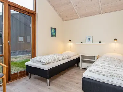 two beds in a room with a window at 8 person holiday home in Ulfborg in Thorsminde