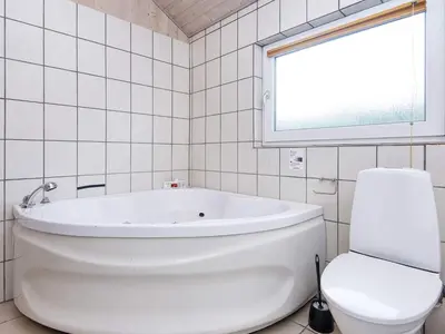 a white bathroom with a tub and a toilet at 6 person holiday home in Harboøre-By Traum in Harboør