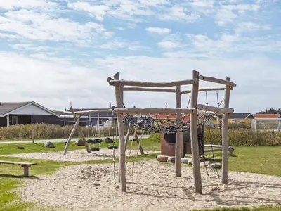 a playground with a net in the sand at 6 person holiday home in Harboøre-By Traum in Harboør