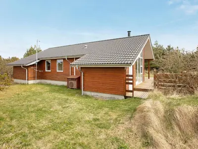 a wooden house with a yard in front of it at Luxury Eco Cottage in Klitmoller - By Traum Ferienwohnungen in Klitmøller
