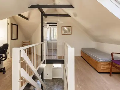 a attic room with a staircase and a bed at 8 person holiday home in Højslev-By Traum in Bøstrup