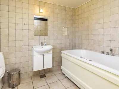 a bathroom with a tub and a sink and a toilet at 8 person holiday home in Højslev-By Traum in Bøstrup