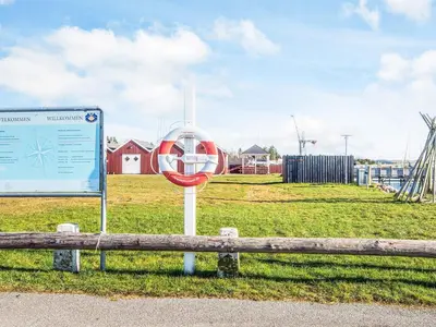 a sign sitting next to a bench in a field at 8 person holiday home in Skals-By Traum in Sundstrup