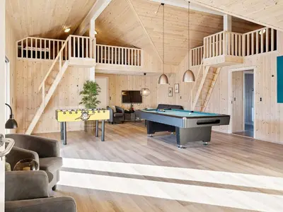 a living room with a pool table and stairs at Luxury Pool Retreat by Sea - By Traum Ferienwohnungen in Harboør