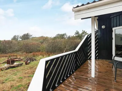 a porch of a house with a wooden deck at Luxury Retreat near Beach - By Traum Ferienwohnungen in Blokhus