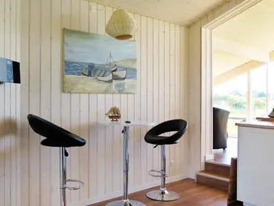 a room with two bar stools and a painting on the wall at 6 person holiday home in Lemvig-By Traum in Trans