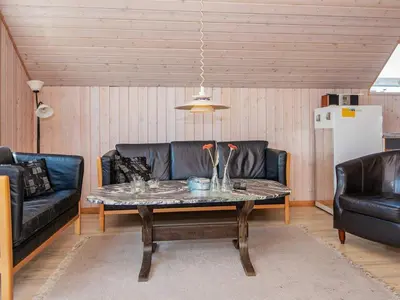 a living room with two black leather couches and a table at 6 person holiday home in Harboøre-By Traum in Harboør