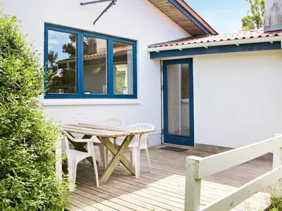 a wooden deck with a table and chairs on a house at 8 person holiday home in Fjerritslev-By Traum in Slettestrand