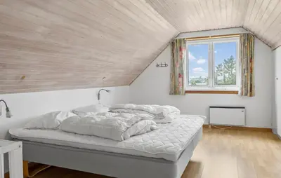 a bedroom with a bed with white sheets and a window at Cozy Home In Øster Assels With Wifi in Øster Assels