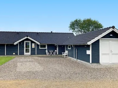 a blue house with a white garage at 6 person holiday home in Vinderup-By Traum in Vinderup