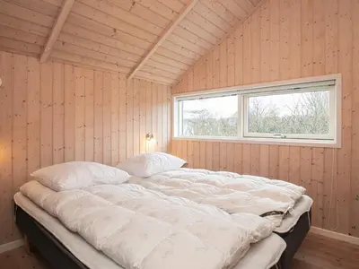 a large bed in a room with a window at 6 person holiday home in Vinderup-By Traum in Vinderup