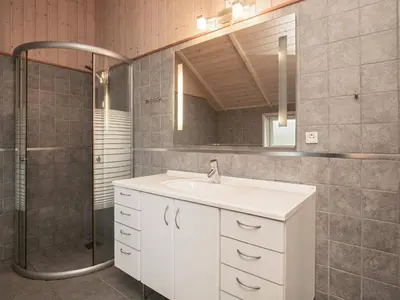 a bathroom with a white sink and a shower at 6 person holiday home in Vinderup-By Traum in Vinderup