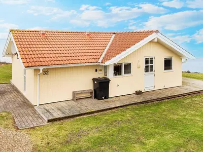 a small white house with a large backyard at 4 person holiday home in Vinderup-By Traum in Vinderup