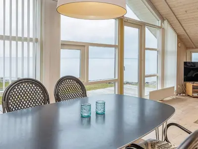 a table with two cups on it in a room with windows at 4 person holiday home in Vinderup-By Traum in Vinderup