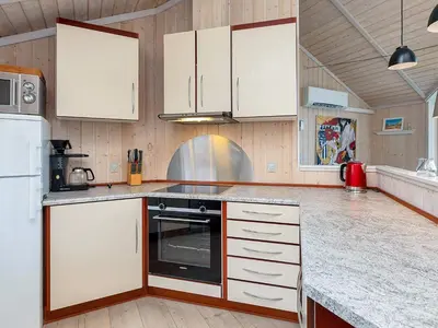 a kitchen with white cabinets and a stove at 4 person holiday home in Vinderup-By Traum in Vinderup