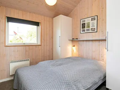 a bedroom with a bed and a window at 8 person holiday home in Lemvig-By Traum in Lemvig