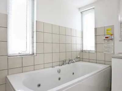 a white bath tub in a bathroom with windows at 8 person holiday home in Brovst-By Traum in Brovst