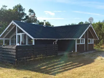 a house with a fence in front of it at Cozy Retreat with Spa - By Traum Ferienwohnungen in Stenbjerg