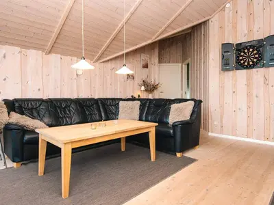 a living room with a black leather couch and a table at 8 person holiday home in Harboøre-By Traum in Harboør