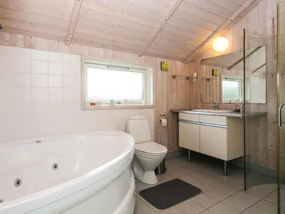 a bathroom with a tub and a toilet and a sink at 8 person holiday home in Harboøre-By Traum in Harboør