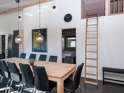 a dining room with a wooden table and chairs at 10 person holiday home in Løgstør-By Traum in Trend