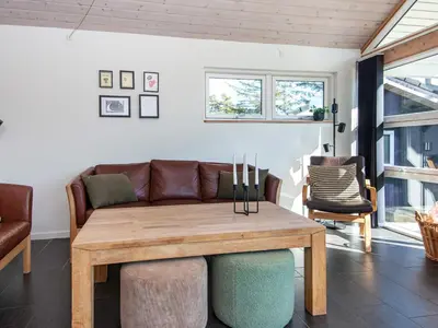 a living room with a couch and a table at 10 person holiday home in Løgstør-By Traum in Trend