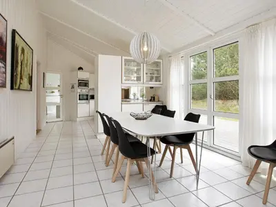 a kitchen and dining room with a table and chairs at Luxury Retreat with Pool - By Traum Ferienwohnungen in Grønhøj