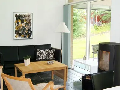 a living room with a couch and a table at 6 person holiday home in Struer-By Traum in Remmer Strand