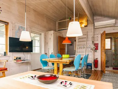 a dining room with a table and blue chairs at 6 person holiday home in Roslev-By Traum in Flovtrup