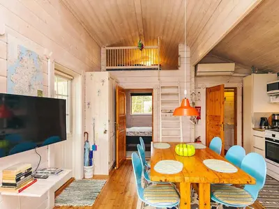 a dining room with a wooden table and blue chairs at 6 person holiday home in Roslev-By Traum in Flovtrup