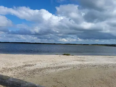 a sandy beach with a large body of water at 10 person holiday home in Løgstør-By Traum in Trend