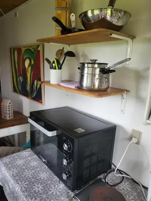 a small kitchen with a stove in a room at Astrup vig Spa og Sauna in Roslev