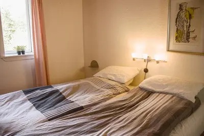 a bedroom with two beds in it with a window at Astrup vig Spa og Sauna in Roslev