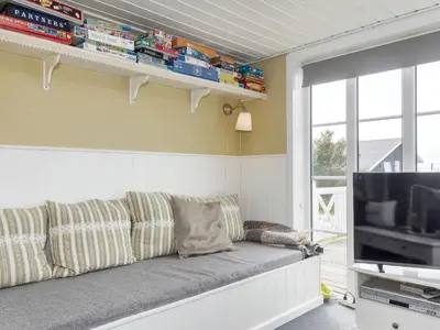 a living room with a couch and a television at 8 person holiday home in Løgstør-By Traum in Trend