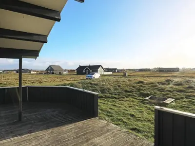a porch of a house with a view of a field at Seaside Fun & Relaxation-By Traum in Harboør