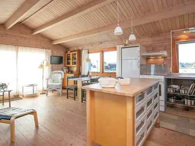 a large kitchen with a counter in a room at Seaside Fun & Relaxation-By Traum in Harboør